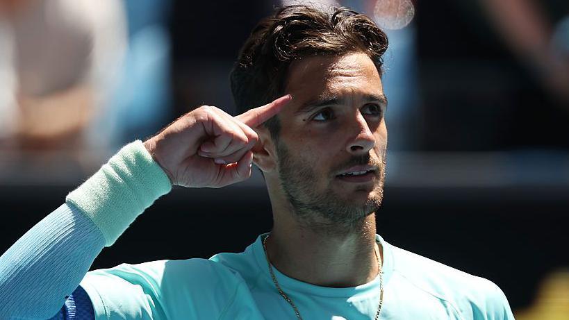 Lorenzo Musetti celebrates after defeating Lorenzo Sonego