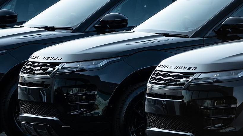 A row of black Land Rover cars