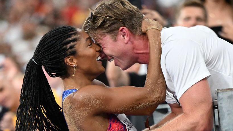 Tara Davis-Woodhall and husband Hunter Woodhall celebrate her Olympic gold