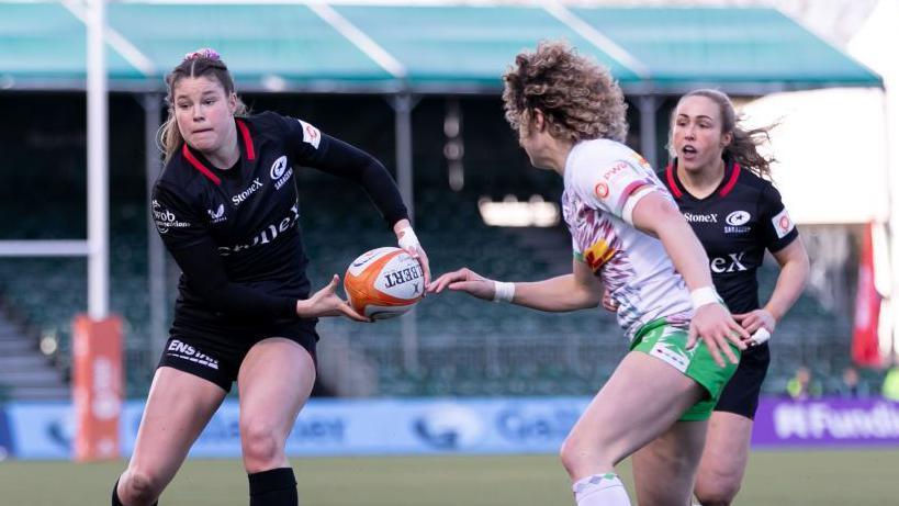 Jess Breach (left) goes to pass the ball during the semi-final 