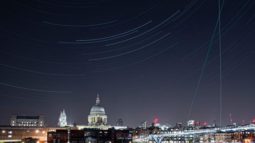 The London Millennium Footbridge is illuminated under the stars on a clear night on April 22, 2020 in London, England. The clear skies created by the New Moon coincide with the Lyrid meteor shower, an annual display caused by the Earth passing through a cloud of debris from a comet called C/186 Thatcher