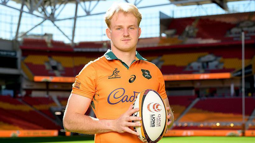 Tom Lynagh poses with a rugby ball
