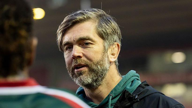 Leicester Tigers head coach Geoff Parling. He is wearing a green jumper and has a slight smile on his face. 