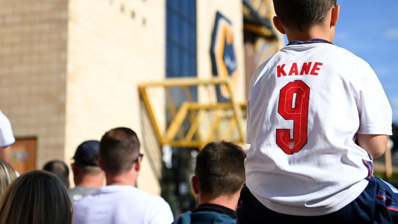 Child wearing England shirt