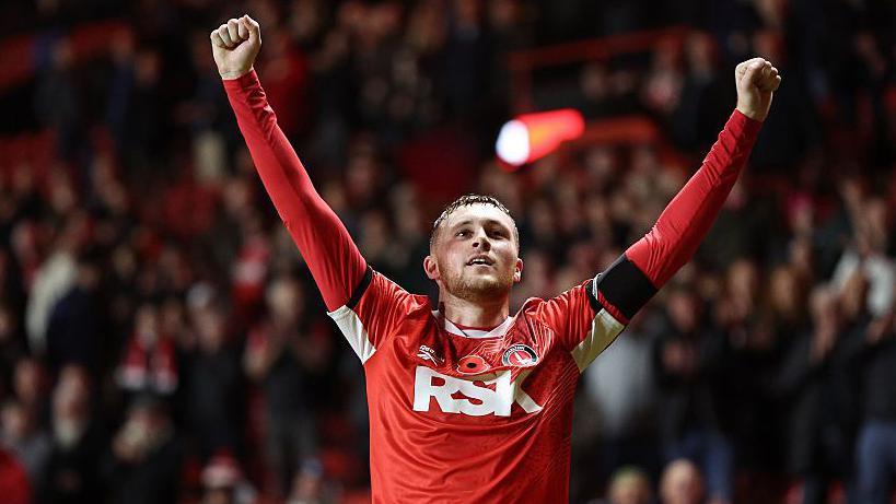 Sonny Carey celebrates with his arms raised