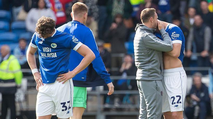 Cardiff City players look dejected as their relegation to League One is confirmed