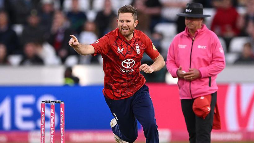 Liam Dawson celebrates a wicket while play in a T20 for England