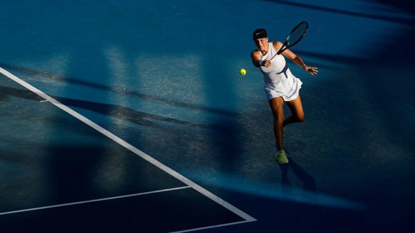 Tatjana Maria of Germany plays a backhand against Bernarda Pera of the United States in their Women's Singles First Round match during day one of the 2025 Australian Open at Melbourne Park