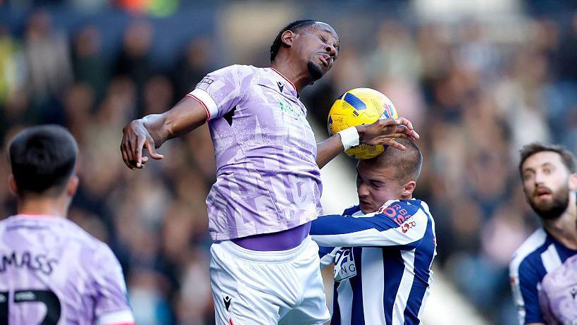 Alfie Gilchrist of West Bromwich Albion wins a headed challenge with Jamal Lowe of Sheffield Wednesday