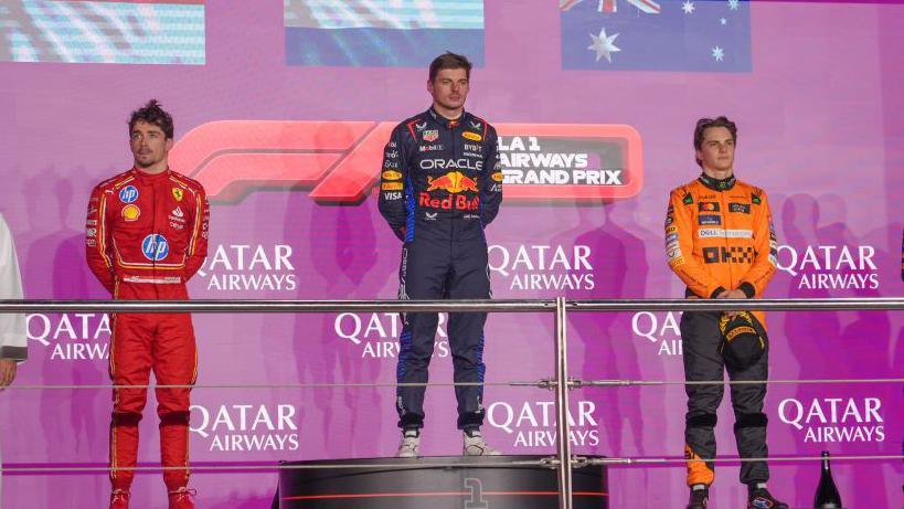 Max Verstappen, Charles Leclerc and Oscar Piastri standing on the podium
