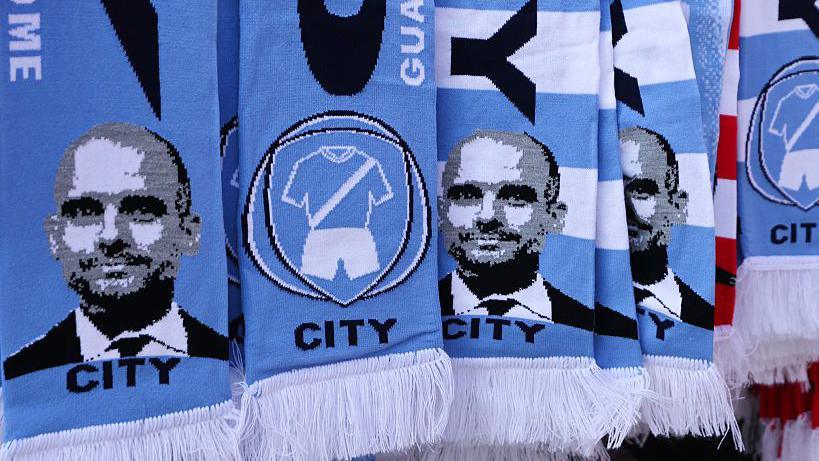 A scarf features Pep Guardiola