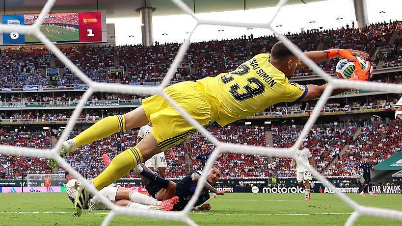 Spain goalkeeper Unai Simon stretches to collect the ball during the World Cup group-stage victory over Uruguay