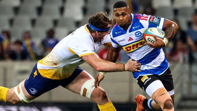 Leolin Zas is tackled by Ryan Baird