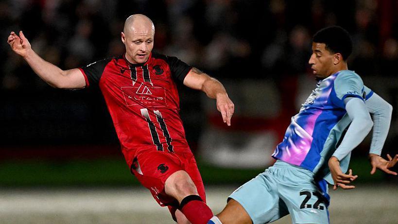 Tom Tonks and Azeem Abdulai competing for the ball.