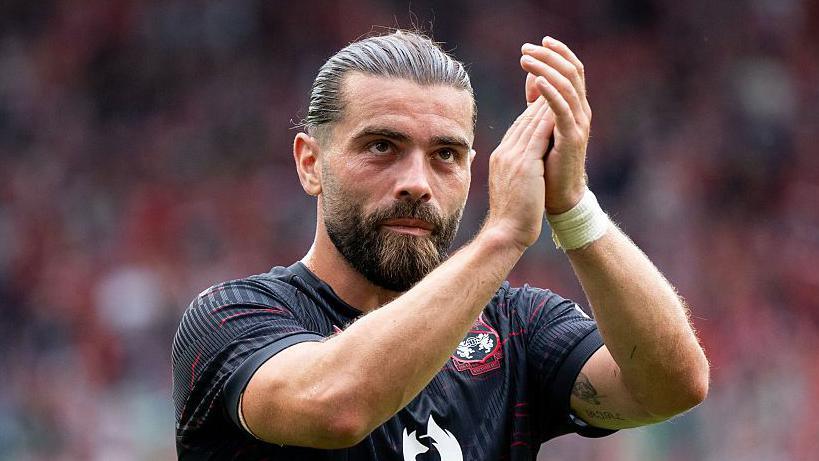 Elliot Lee applauds the Wrexham fans following their 0-0 draw against Polish side Wisla Krakow.