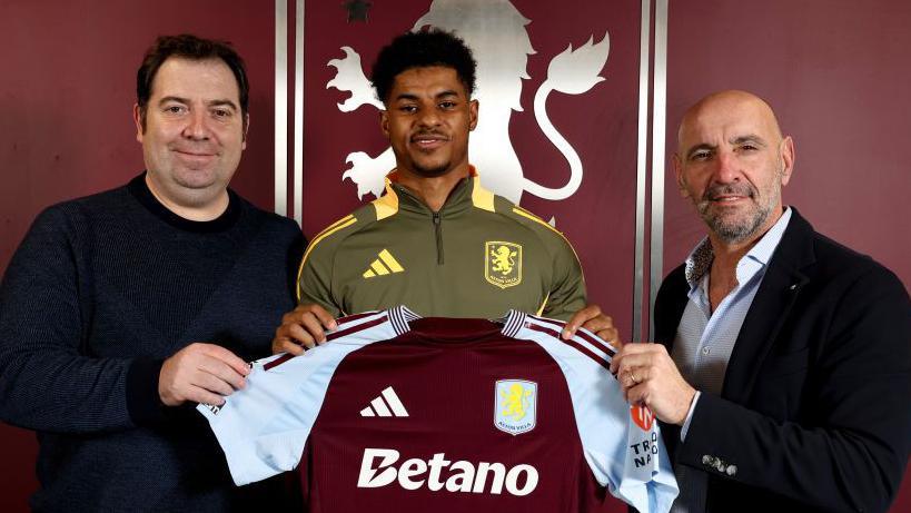 Marcus Rashford, pictured with Aston Villa director of football operations Damian Vidagany (l) and president of football operations Monchi.