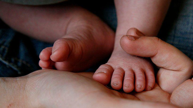 A close up of a pair of baby's feet.