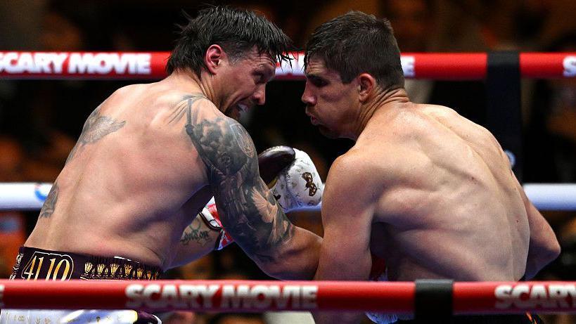 Oleksandr Usyk and Rico Verhoeven punch each other