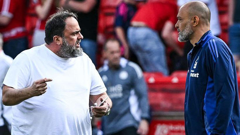 Nuno Espirito Santo speaking to Evangelos Marinakis on the pitch after a game against Leicester in May