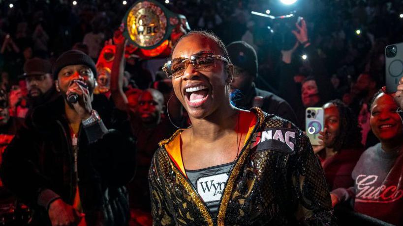 Claressa Shields smiling on her ring walk before her fight with Danielle Perkins