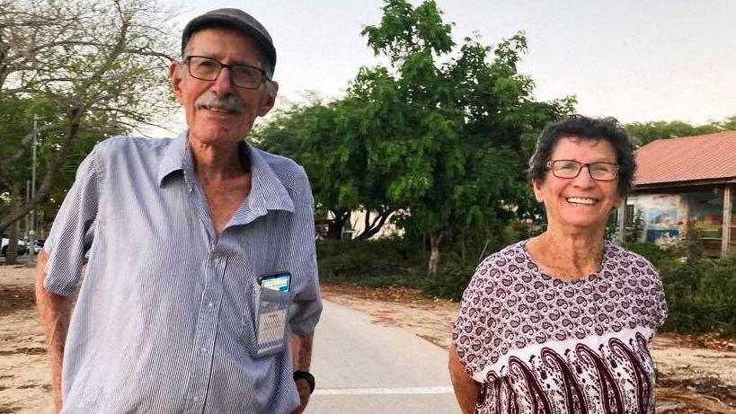 Oded Lifschitz (left) is still being held hostage in Gaza, his wife Yocheved (right) was also taken hostage but released in a deal - The pair are seen here smiling and in casual clothing, standing outside in what appears to be a sunny country, presumably Israel 