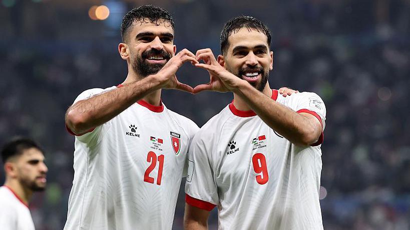 Nizar Al-Rashdan celebrates with his Jordan team-mate Ali Olwan 