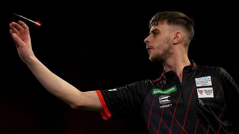 Dom Taylor throws a dart