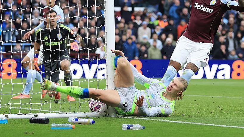 Manchester City striker Erling Haaland collides with post
