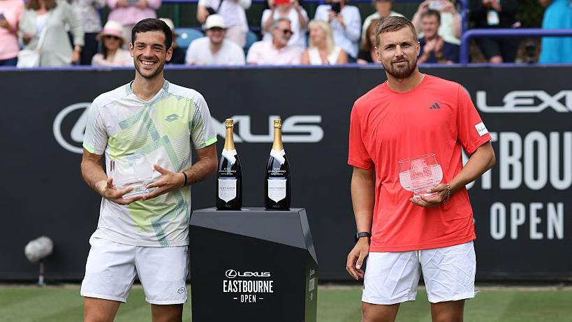 Julian Cash and Lloyd Glasspool celebrate with their trophies