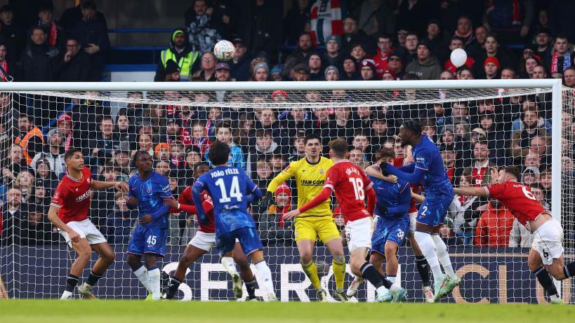 Morecambe fans hoist banners demanding that owner Jason Whittingham sells the club during the FA Cup tie against Chelsea at Stamford Bridge