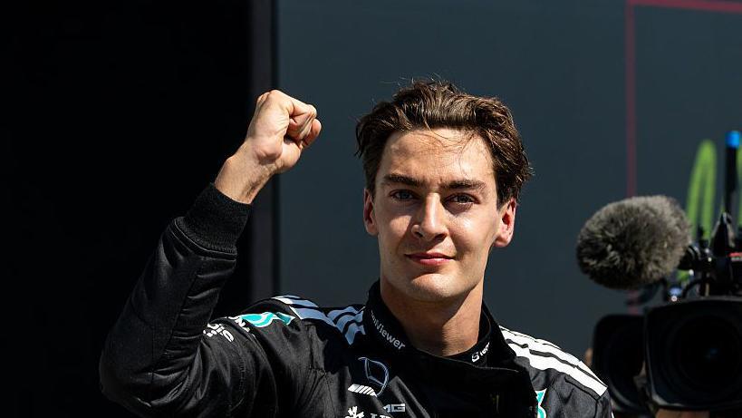 George Russell throwing a fist in the air to celebrate winning the Canadian Grand Prix
