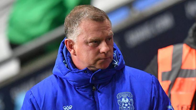 Mark Robins looks on from the touchline as Coventry boss.