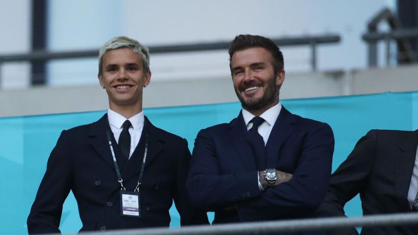 Romeo Beckham and David Beckham, Former England International react as they watch on from the stands 