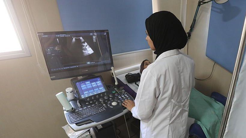 A pregnant woman is given an ultrasound at Hilwa hospital in Gaza City, northern Gaza (24 May 2025)