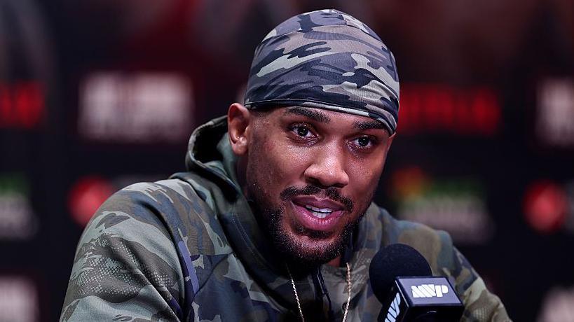 Anthony Joshua speaking during a news conference before his fight against Jake Paul