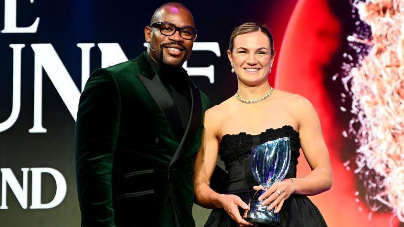 Ellie Kildunne [right] is presented with the World Rugby women's world player of the year award by Ugo Monye [left]