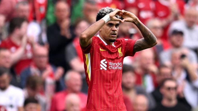 Liverpool midfielder Luis Diaz makes a heart shape with his hands in celebration