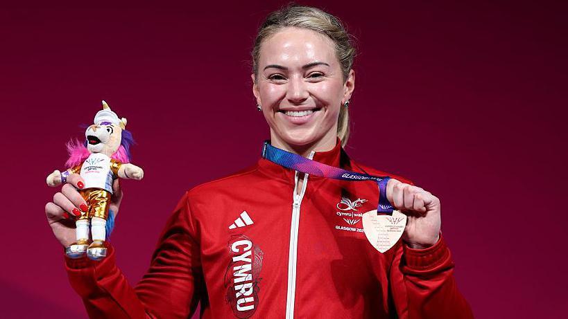 Laura Hughes, who returned to weightlifting after taking a break from the sport, poses with her bronze medal