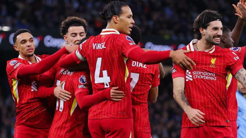 Liverpool players celebrate the win at Manchester City that points them eleven points clear of Arsenal at the top of the Premier League