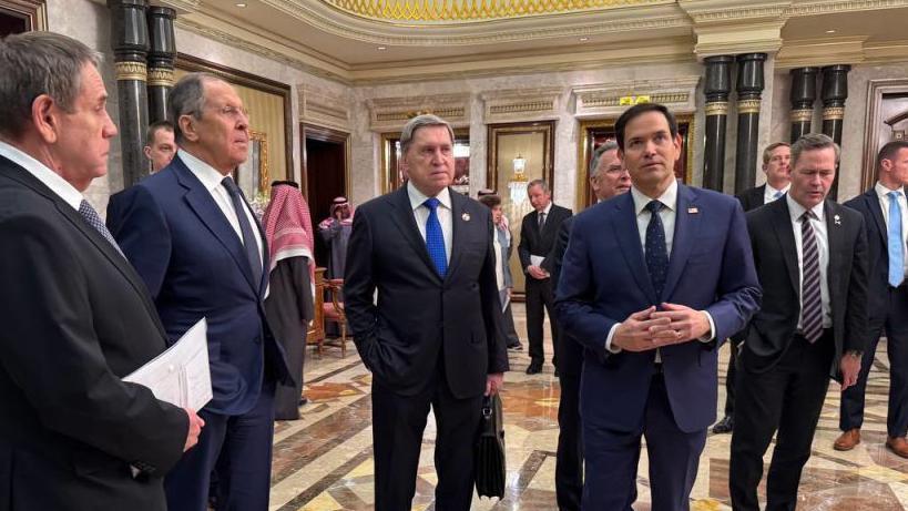 Russian Foreign Minister Sergey Lavrov (C) and Russian President Vladimir Putin's Foreign Policy Advisor Yuri Ushakov (2nd R) chat with Saudi Arabian officials, following meeting between Russia and the United States in Ukraine, in Riyadh, Saudi Arabia,