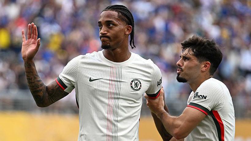 Joao Pedro holds his hand up after scoring for Chelsea