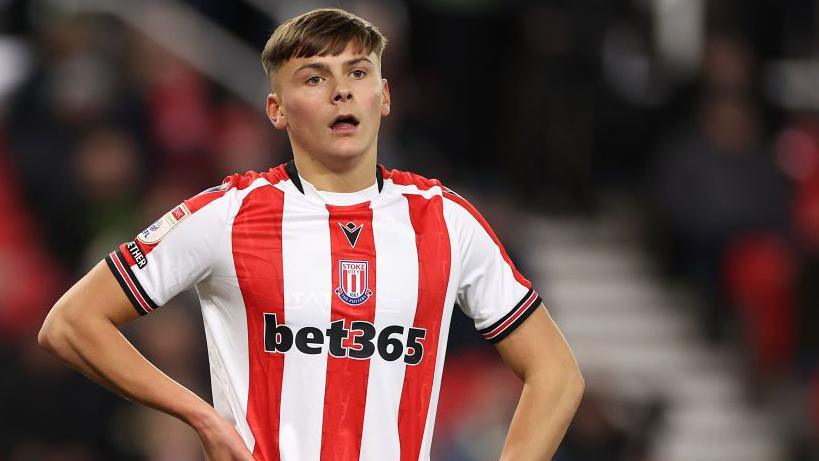 Emre Tezgel standing with his hand on his hip during a game for Stoke City