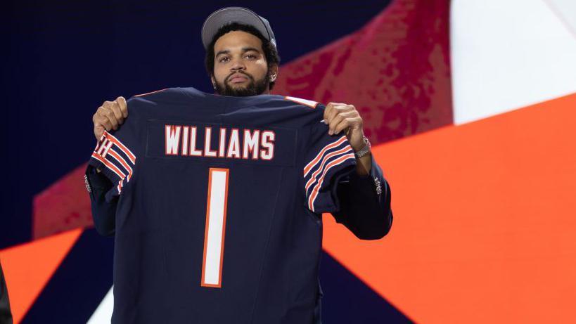 Williams holds his Chicago Bears shirt