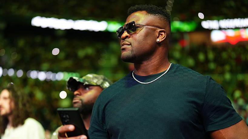 Francis Ngannou at cageside with sunglasses on