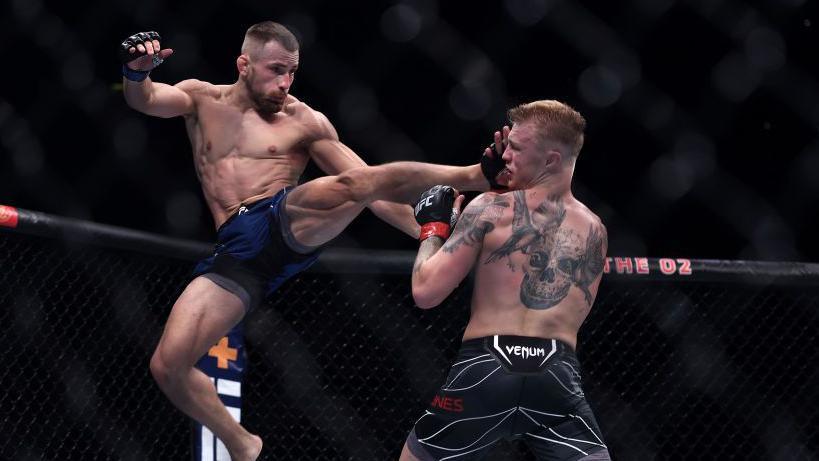 Ludovit Klein of Slovakia kicks Mason Jones of Wales in the face 