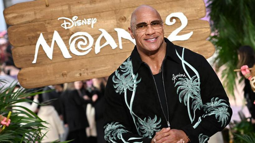 Dwayne Johnson stands on the red carpet at the Moana 2 premiere in London