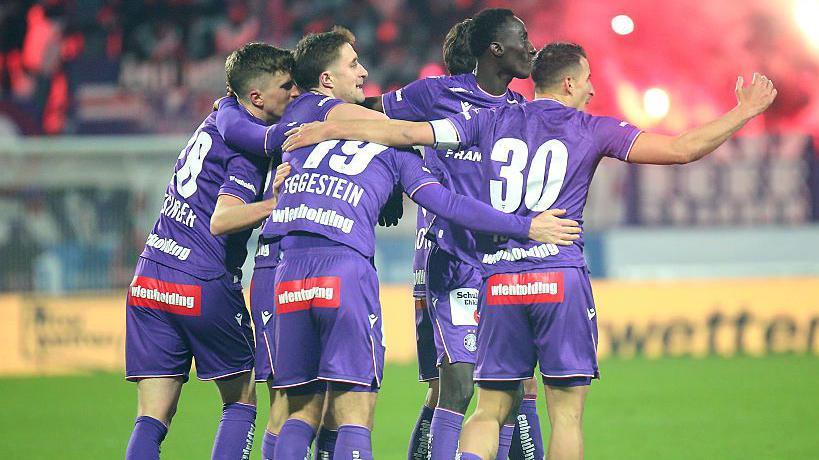 Philipp Wiesinger, Johannes Eggestein, Abubakr Barry and Manfred Fischer of Austria Vienna celebrate a goal against Rapid Vienna