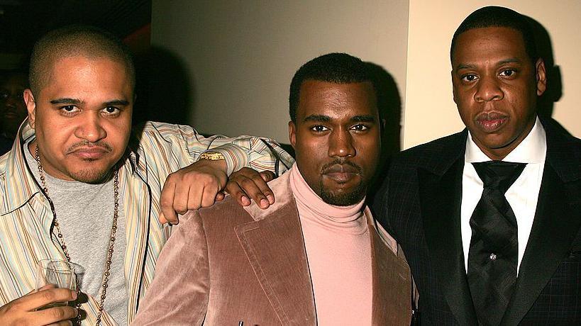 Irv Gotti, Kanye West and Jay-Z pose while holding champagne glasses in the early 2000s