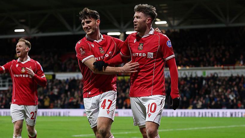 Wrexham's Ryan Longman (left) celebrates with Josh Windass (right)