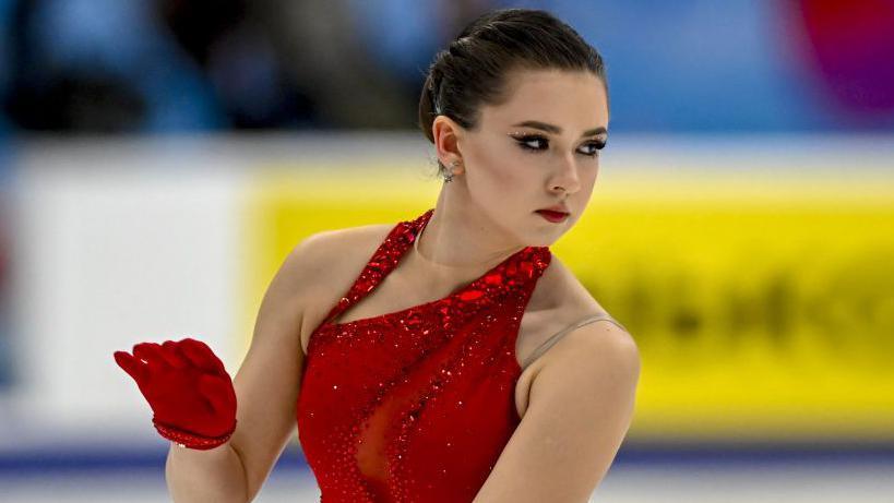 Kamila Valieva in red skating outfit